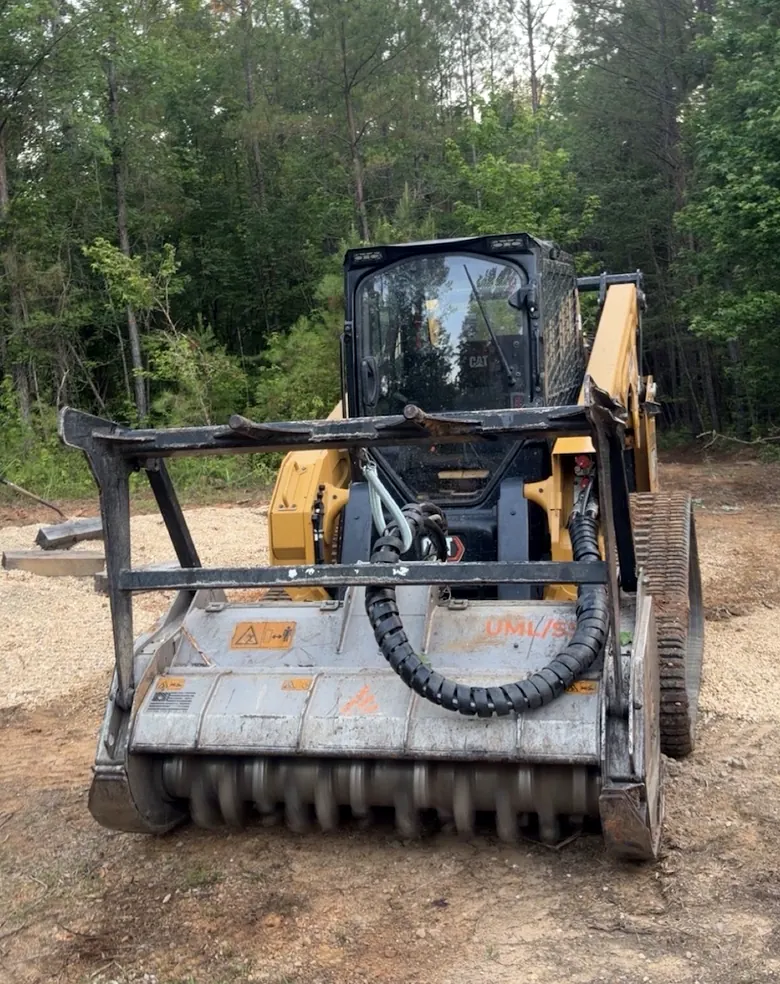 Cat compact track loader fitted with a drum forestry mulching head